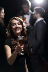 happy young woman raising glass in toast