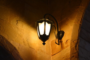 orange lamp on the old wall ad dusk