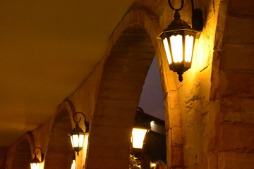 orange lamps on the old wall ad dusk