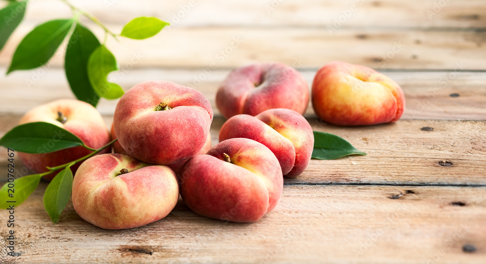 Wall mural fresh peaches on wooden table