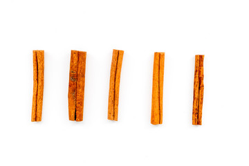 Cinnamon sticks on white background top view. Condiment for mulled wine