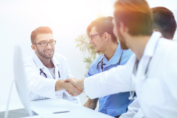 Fototapeta premium handshake between the two doctors during the working meeting