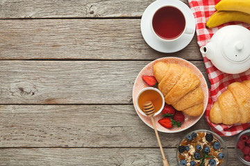 Tasty pastry, fruits and berries on rustic wood, top view