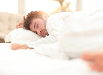 closeup.the tired men sleep soundly on the bed