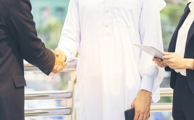 Professional Arab businessman entrepreneur make handshake with businessman, trusting to run business together. Promise to collaboration, share knowledge, innovation and skill coordination as teamwork