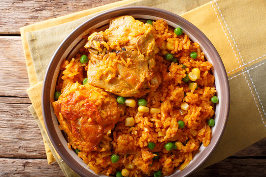 Galinhada is the Brazilian version of arroz con pollo chicken and rice close-up on a plate. horizontal top view