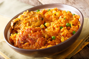 Galinhada - stew chicken, typical Brazilian dish. rice made with chicken, saffron, and vegetables close-up. Horizontal