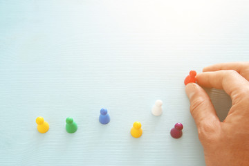 image of colorful game figures over wooden table ,human resources and management concept.