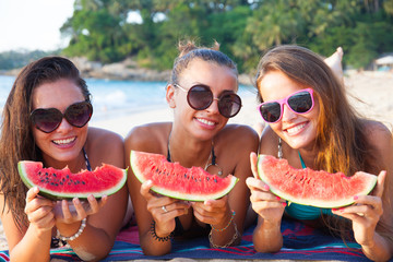 Female friends eating watermelon