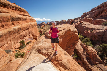 Hiker rests in Arches National park in Utah, USA