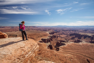 Hiker rests in Canyonlands National park in Utah, USA