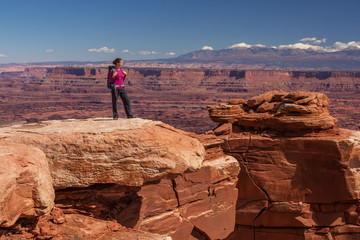 Hiker rests in Canyonlands National park in Utah, USA