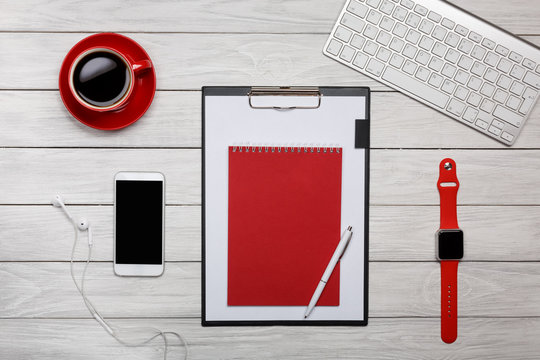 white board desk folder red notepad cup of coffee clock keyboard working process