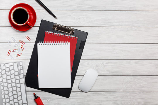 white board desk folder red shuttles cup of coffee clock paper clips keyboard mouse working process at the computer