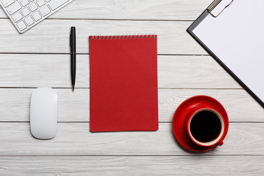 white table boards folder red notepad cup morning coffee workflow preparation meeting