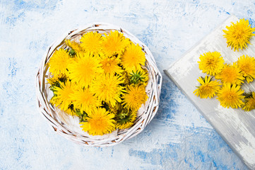 Dandelion flowers in wicker bowl top view © creativefamily
