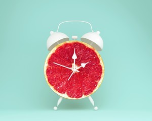 Creative idea layout fresh grapefruit slice alarm clock on pastel blue background. minimal idea business concept. fruit idea creative to produce work within an advertising marketing communications