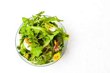 Dandelion salad in a bowl top view