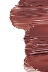 Texture of brown lipstick isolated on white. Smear of broken brown lip gloss