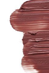 Texture of brown lipstick isolated on white. Smear of broken brown lip gloss