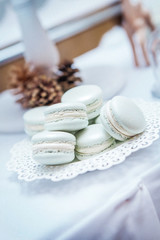 delicious macarons with filling are standing on the plate in the restaurant