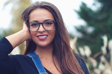 woman smiling eyeglasses portrait outdoor forest