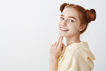 Attractive redhead woman with blue eyes feeling happy. Natural beauty concept. Studio shot of...