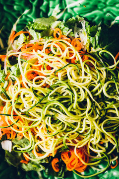   Vegetables sliced julienne for an healthy salad, with a domestic tool to cut the vegetables.