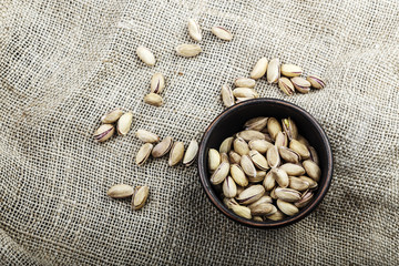 pistachios in a plate on sacking