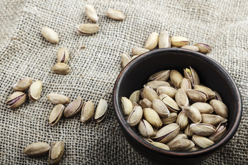 pistachios in a plate on sacking