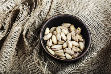 pistachios in a plate on sacking