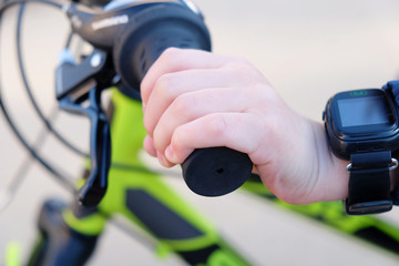 child's hand on a Bicycle handlebar