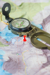 Set of map, red push pin and compass for successful traveler