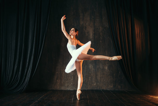 Fototapeta Ballerina in white dress dancing in ballet class