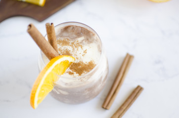 Chocolate-vanilla mousse with an orange slice on a white marble table