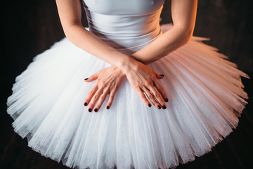Classical ballet dancer in dress and cross hands