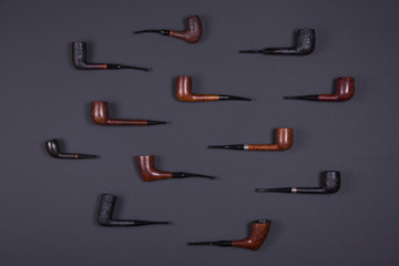 Smoking pipes on dark background.
