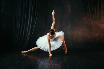 Naklejka premium Grace of ballerina in motion on theatrical stage