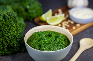 Pesto from kale. Ingredients on the background