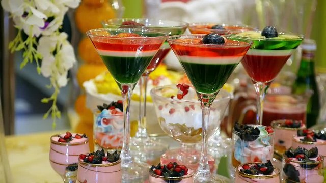 multicolored fruit dessert jelly in glass. wedding celebratory dinner food design slide movement