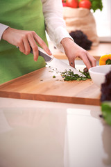 Close Up of human hands cooking vegetable salad in kitchen on the glass table with reflection. Healthy meal, and vegetarian food concept