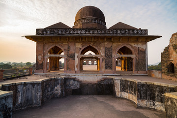 Mandu India, afghan ruins of islam kingdom, mosque monument and muslim tomb. View through door,...