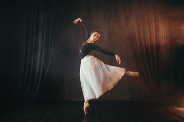 Obraz premium Classical ballet dancer in motion on the stage
