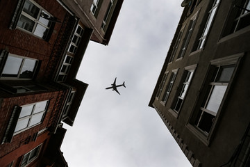 Fototapeta na wymiar Airplane passing over Fener District in Istanbul, Turkey