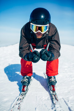 Skier racing from the mountain, front view