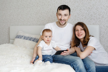 portrait of a beautiful young family with a small child