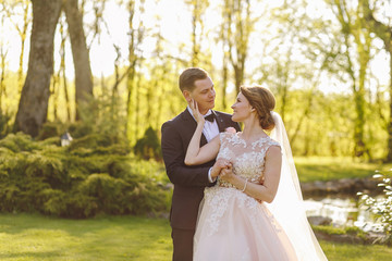 bride and groom walking in the forest