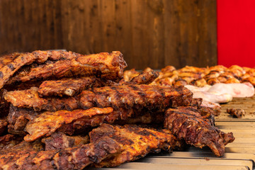 the meat on ribs cooked on the grill, street food fair in Italy.