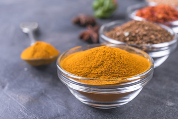 Set of colorful spices   on a dark  background.