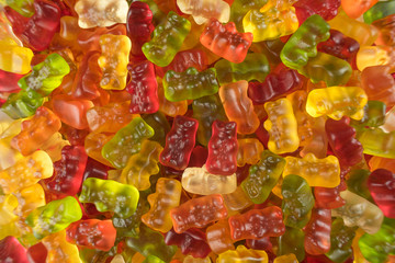 Heap of colorful jelly babies / gummy bear candy sweets. Potential use as a background.